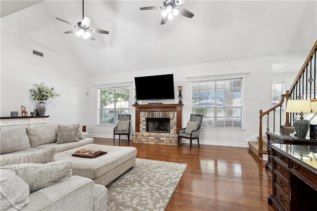 126 Rue Acadian, Belle Chasse, LA 70037 - living room featuring a ceiling fan, stairs, high vaulted ceiling, a fireplace, and dark wood-style flooring
