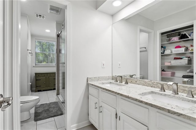 126 Rue Acadian, Belle Chasse, LA 70037 - bathroom featuring toilet, double vanity, a shower stall, tile patterned flooring, and recessed lighting