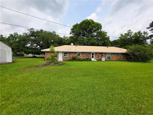 46282 Morris Rd, Hammond, LA 70401 - back of house featuring a lawn and cooling unit