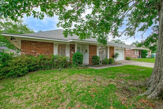 1414 Englewood Dr, Slidell, LA 70458 - ranch-style house featuring brick siding, a garage, concrete driveway, a front yard, and roof with shingles