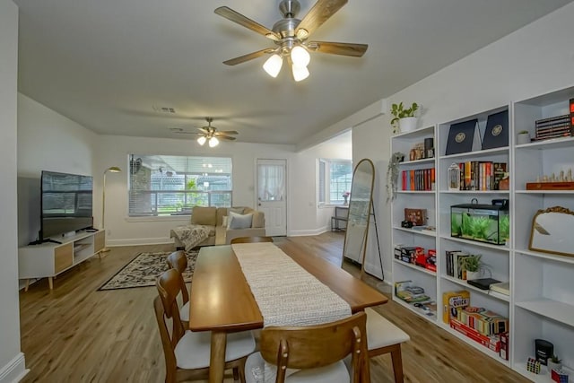 1414 Englewood Dr, Slidell, LA 70458 - dining space featuring wood finished floors, ceiling fan, and baseboards
