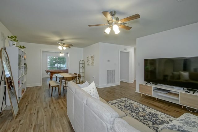 1414 Englewood Dr, Slidell, LA 70458 - living room featuring a ceiling fan, light wood finished floors, and baseboards
