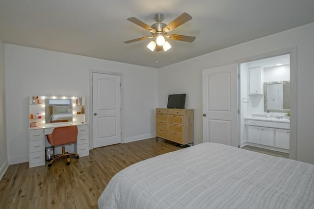 1414 Englewood Dr, Slidell, LA 70458 - bedroom featuring light wood-style floors, baseboards, an office area, connected bathroom, and ceiling fan