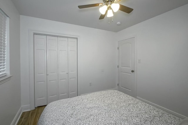 1414 Englewood Dr, Slidell, LA 70458 - bedroom with baseboards, a closet, wood finished floors, and a ceiling fan