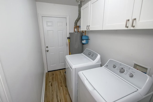 1414 Englewood Dr, Slidell, LA 70458 - laundry room with separate washer and dryer, water heater, wood finished floors, and cabinet space