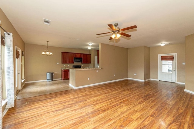 413 Oakley Blvd, Pearl River, LA 70452 - unfurnished living room featuring a ceiling fan, a chandelier, light wood-type flooring, and baseboards