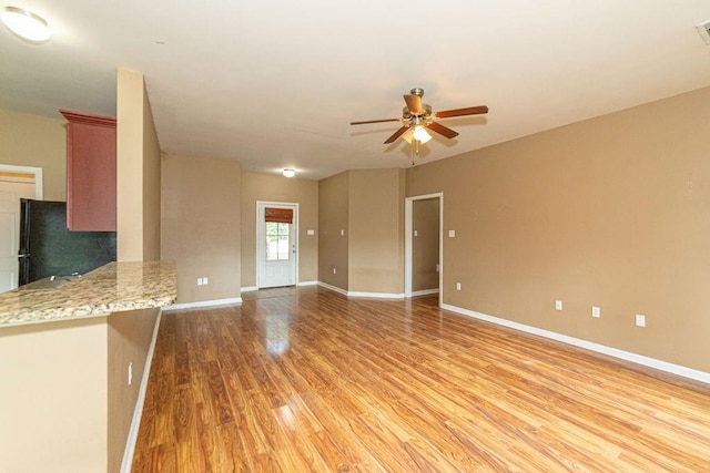 413 Oakley Blvd, Pearl River, LA 70452 - unfurnished living room featuring light wood-style flooring, ceiling fan, and baseboards