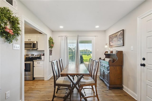 1017 Ridgefield Dr, La Place, LA 70068 - dining area with light wood-style floors, baseboards, and recessed lighting