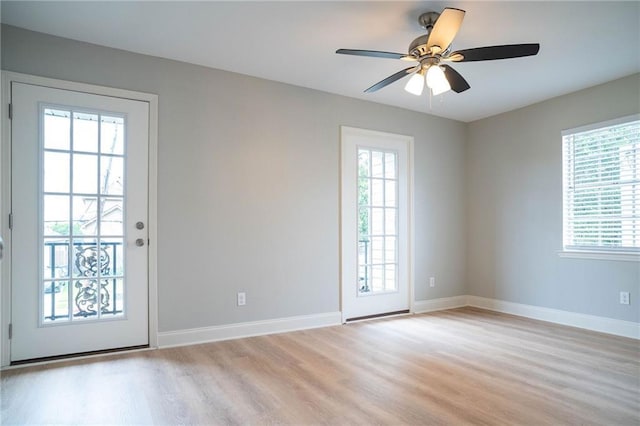408 22 Nd St Unit 408, New Orleans, LA 70124 - doorway to outside featuring healthy amount of natural light, light wood-style floors, baseboards, and a ceiling fan