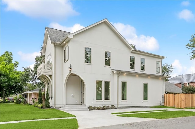 1001 Helios Ave, Metairie, LA 70005 - view of front of house with a balcony, stucco siding, and a shingled roof