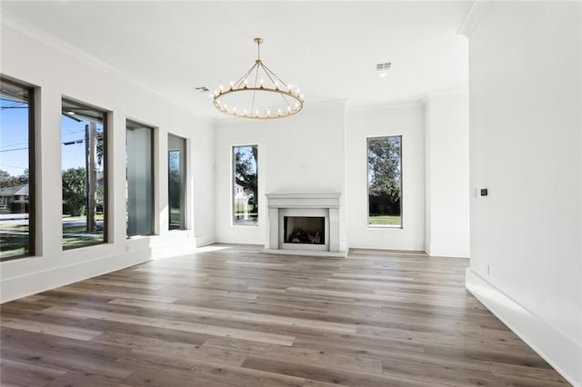 1001 Helios Ave, Metairie, LA 70005 - unfurnished living room with plenty of natural light, a chandelier, crown molding, and wood finished floors