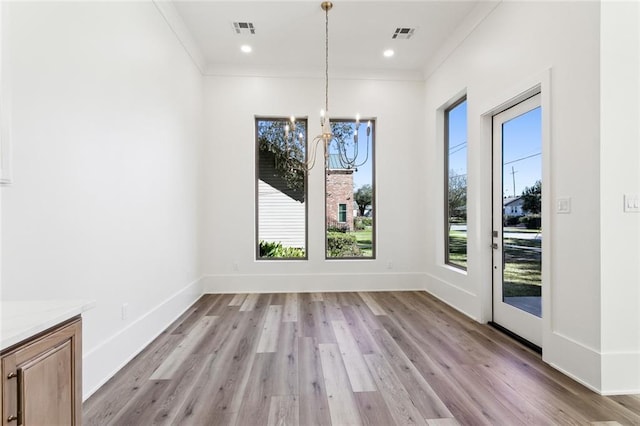 1001 Helios Ave, Metairie, LA 70005 - unfurnished dining area featuring a chandelier, light wood-type flooring, crown molding, baseboards, and recessed lighting
