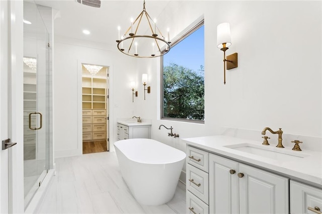 1001 Helios Ave, Metairie, LA 70005 - bathroom with vanity, a stall shower, a chandelier, a freestanding bath, and a walk in closet