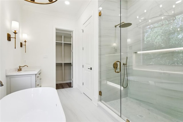 1001 Helios Ave, Metairie, LA 70005 - bathroom featuring a stall shower, a freestanding tub, vanity, and a spacious closet