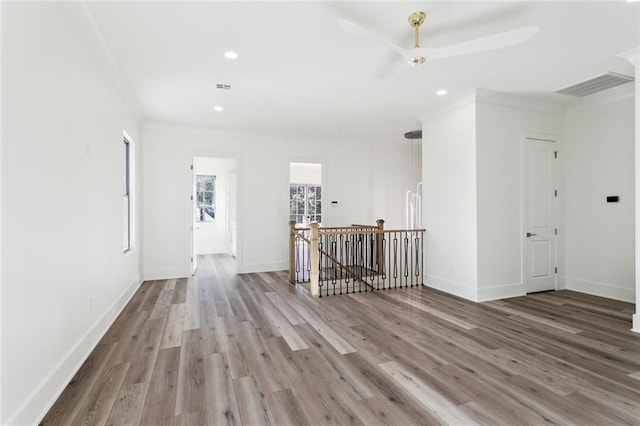 1001 Helios Ave, Metairie, LA 70005 - empty room with wood finished floors, recessed lighting, crown molding, and baseboards