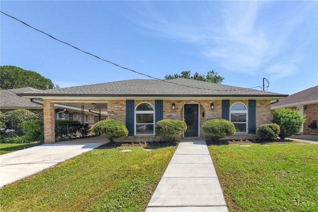 5024 Rye St, Metairie, LA 70006 - view of front of house featuring a front yard, brick siding, driveway, and a carport