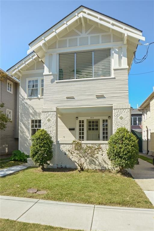 221012 Pine St, New Orleans, LA 70118 - view of front of house with a front lawn and stone siding