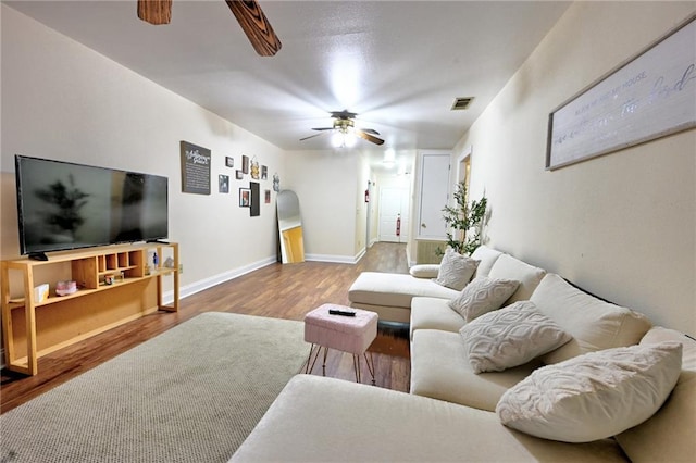 7701 Allison Rd, New Orleans, LA 70126 - living room with a ceiling fan, wood finished floors, and baseboards