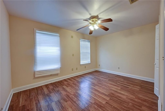 7701 Allison Rd, New Orleans, LA 70126 - spare room featuring a ceiling fan, wood finished floors, and baseboards