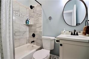 324 N Roman St, New Orleans, LA 70112 - full bath with vanity, shower / bath combination with curtain, and toilet