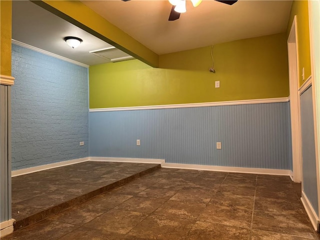 570 Central Ave, Reserve, LA 70084 - empty room featuring a ceiling fan, a wainscoted wall, baseboards, and stone finish flooring