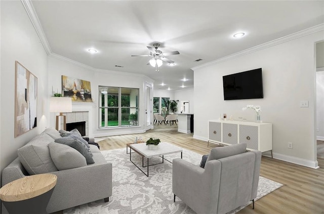 130 Palm Beach Blvd, Madisonville, LA 70447 - living area featuring ornamental molding, wood finished floors, ceiling fan, a tiled fireplace, and baseboards