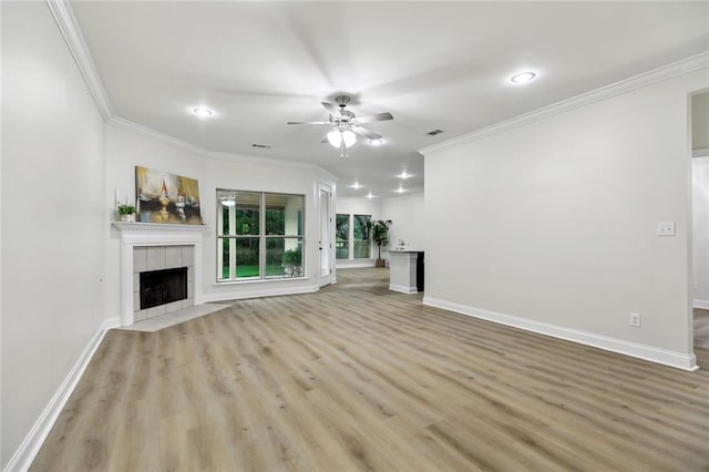 130 Palm Beach Blvd, Madisonville, LA 70447 - unfurnished living room with a ceiling fan, light wood-type flooring, a fireplace, crown molding, and baseboards
