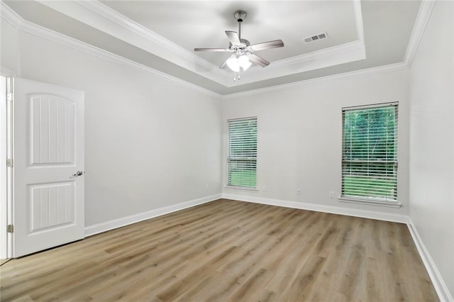 130 Palm Beach Blvd, Madisonville, LA 70447 - unfurnished room featuring wood finished floors, a tray ceiling, ceiling fan, crown molding, and baseboards