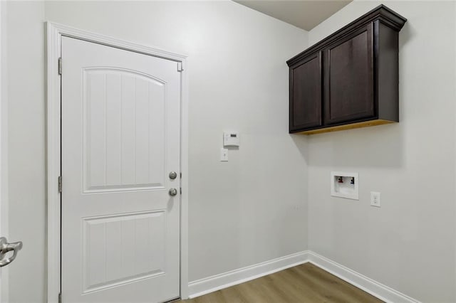 130 Palm Beach Blvd, Madisonville, LA 70447 - washroom with hookup for a washing machine, wood finished floors, cabinet space, and baseboards