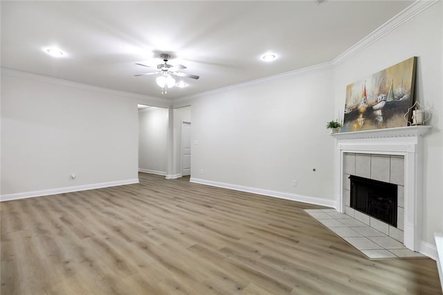 130 Palm Beach Blvd, Madisonville, LA 70447 - unfurnished living room with a ceiling fan, a tiled fireplace, wood finished floors, ornamental molding, and baseboards