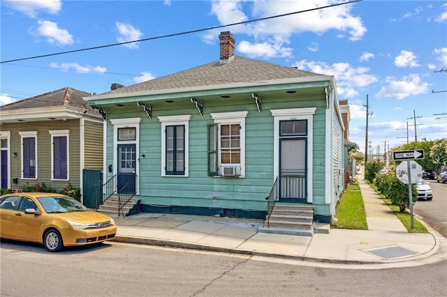 1432-1434 Ursulines Ave, New Orleans, LA 70116 - view of front facade featuring entry steps, a chimney, and cooling unit