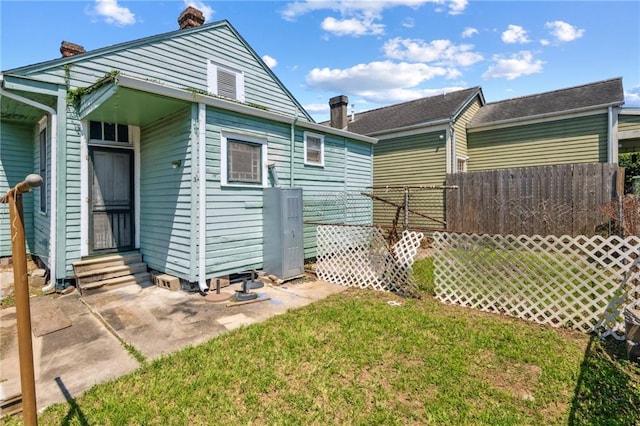1432-1434 Ursulines Ave, New Orleans, LA 70116 - view of side of property with entry steps, a chimney, and a patio