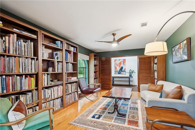 505 Hermitage Ct, Pearl River, LA 70452 - living room featuring wood finished floors, a ceiling fan, and bookshelves