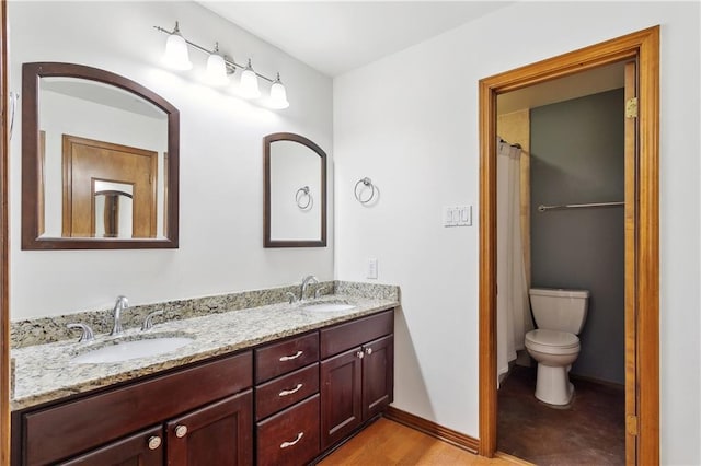 505 Hermitage Ct, Pearl River, LA 70452 - full bathroom with toilet, double vanity, wood finished floors, and baseboards