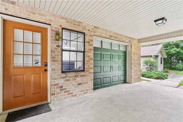 505 Hermitage Ct, Pearl River, LA 70452 - property entrance featuring a garage, brick siding, and driveway