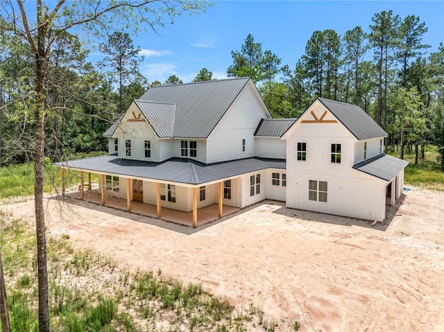 1190 Dove Park Rd, Covington, LA 70433 - rear view of property with dirt driveway, metal roof, and a porch