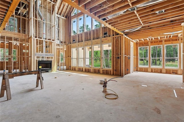 1190 Dove Park Rd, Covington, LA 70433 - misc room with plenty of natural light, a towering ceiling, and a fireplace