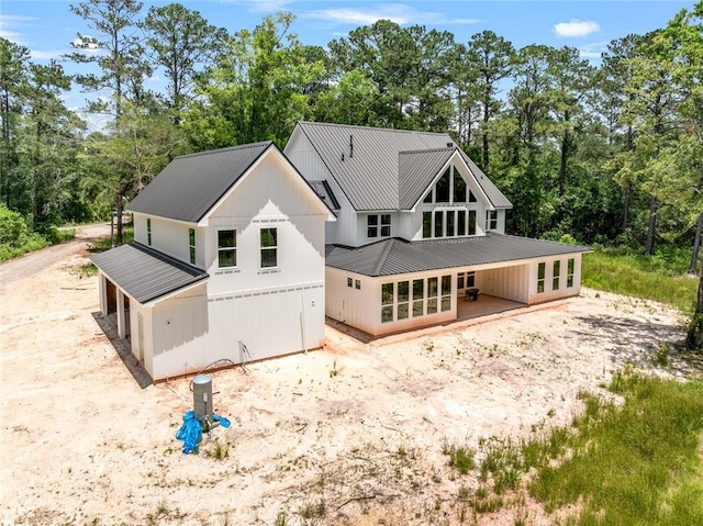 1190 Dove Park Rd, Covington, LA 70433 - rear view of property with french doors, metal roof, and view of wooded area