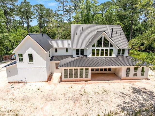1190 Dove Park Rd, Covington, LA 70433 - back of property with view of wooded area and metal roof