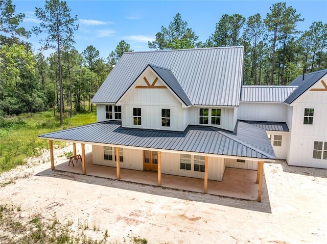 1190 Dove Park Rd, Covington, LA 70433 - back of property with metal roof, covered porch, and board and batten siding