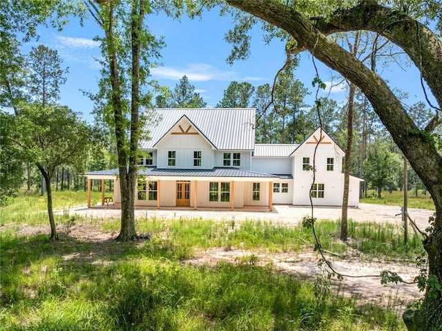 1190 Dove Park Rd, Covington, LA 70433 - back of house with a standing seam roof, metal roof, and dirt driveway