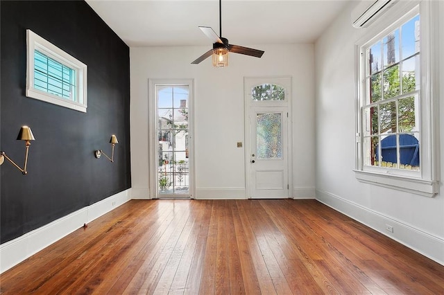 1314 Ursulines Ave, New Orleans, LA 70116 - entryway featuring hardwood / wood-style flooring, plenty of natural light, a ceiling fan, and a wall mounted air conditioner