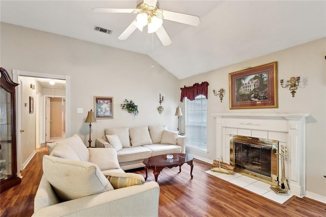 62088 Snow St, Lacombe, LA 70445 - living room with wood finished floors, ceiling fan, vaulted ceiling, a fireplace, and baseboards