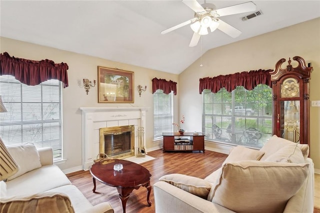 62088 Snow St, Lacombe, LA 70445 - living area with wood finished floors, lofted ceiling, a ceiling fan, a tile fireplace, and baseboards
