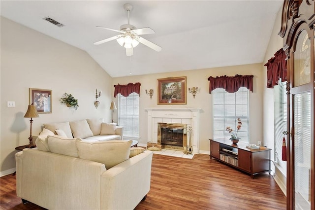 62088 Snow St, Lacombe, LA 70445 - living area featuring lofted ceiling, ceiling fan, wood finished floors, a fireplace, and baseboards