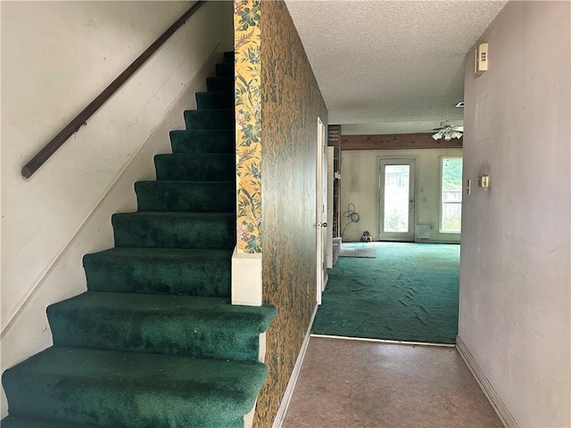 41 Hollycrest Blvd Unit 41, Covington, LA 70434 - stairway featuring carpet flooring, a textured ceiling, baseboards, and ceiling fan
