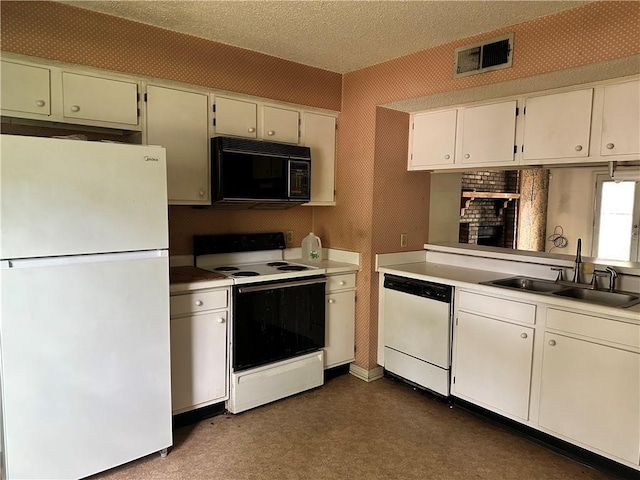 41 Hollycrest Blvd Unit 41, Covington, LA 70434 - kitchen with white appliances, a sink, light countertops, white cabinetry, and a textured ceiling