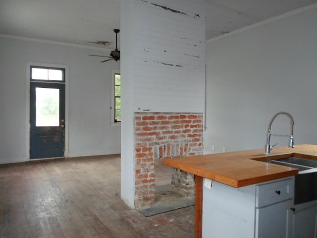 6315 Alhambra St, New Orleans, LA 70117 - kitchen featuring crown molding, hardwood / wood-style flooring, ceiling fan, baseboards, and a sink