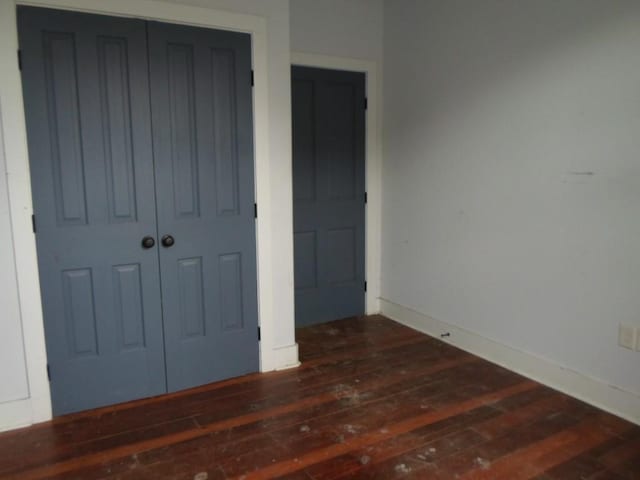 6315 Alhambra St, New Orleans, LA 70117 - unfurnished bedroom with wood-type flooring, baseboards, and a closet