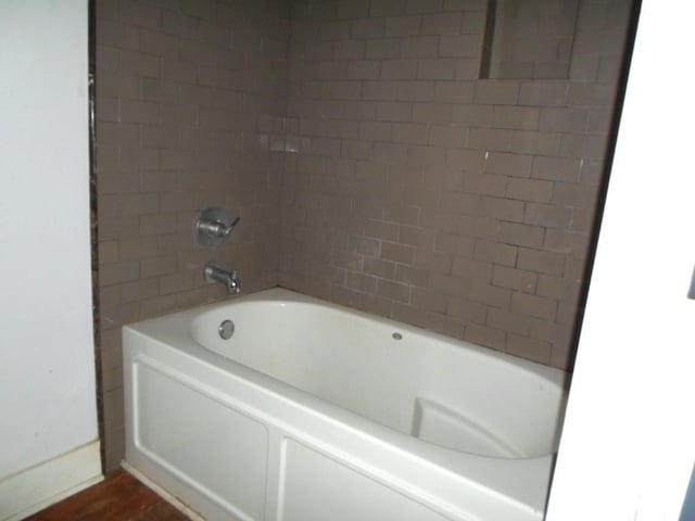 6315 Alhambra St, New Orleans, LA 70117 - full bathroom featuring wood finished floors and  shower combination